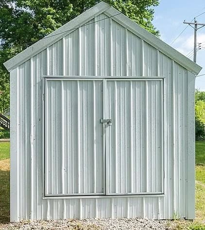white metal A frame shed that we turn into the chicken coop