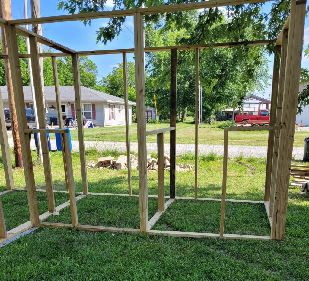 Front view of frame of the two side by side stalls to the goat barn