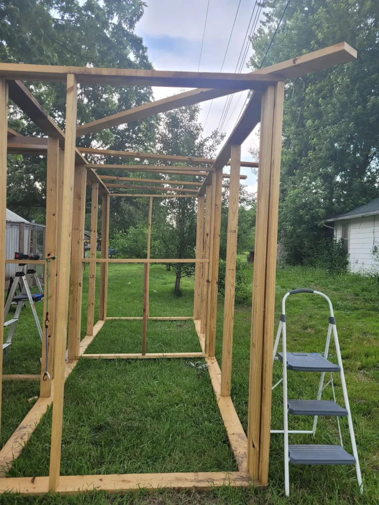 end view of the frame to the long side of the L shaped goat barn that is the milk room and kidding stall