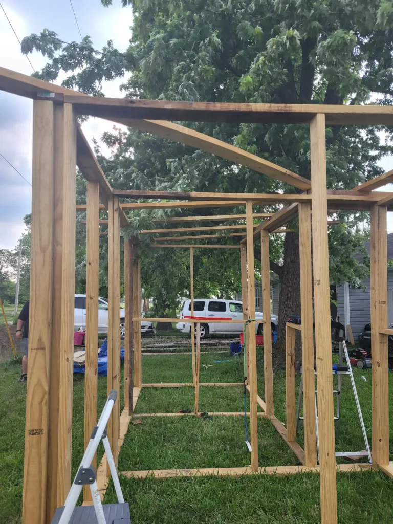 end view of the frame of the two side by side stalls of the goat barn