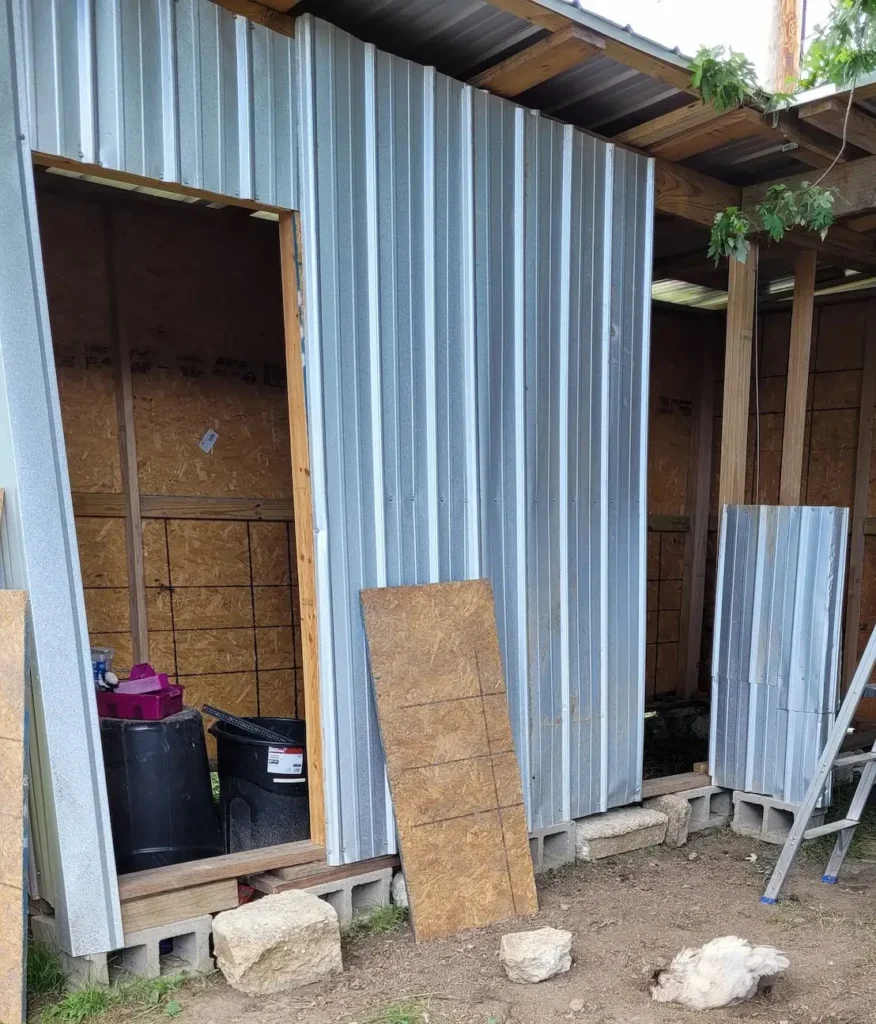 view of goat barn with metal siding on it